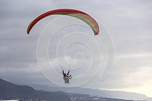 Skydiver in the sky. Silhouette of parachute on sunset background