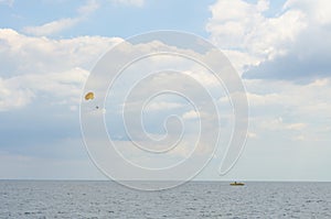 Skydiver in the skyes, in clouds, above the sea