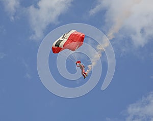 Skydiver with a smoke trail