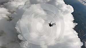 Skydiver turning and entering the clouds.