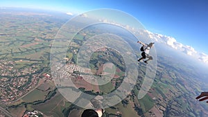 Skydivers in free fall sit fly position.