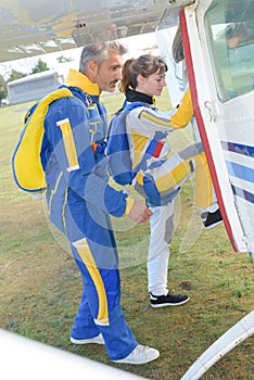 Skydivers getting into airplane