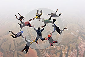 Skydivers holding hands making a fomation. High angle view. photo