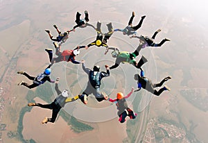 Skydivers holding hands making a fomation. High angle view.