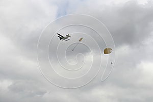 Skydivers jump from an old biplane plane