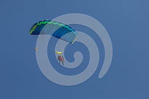 Skydivers parachutist on blue sky on sunset