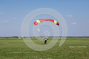 Skydivers parachutist on blue sky on sunset