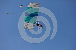 Skydivers parachutist on blue sky on sunset