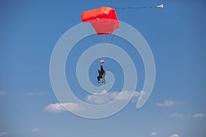 Skydivers parachutist on blue sky on sunset