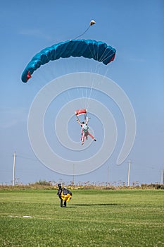 Skydivers parachutist on blue sky on sunset