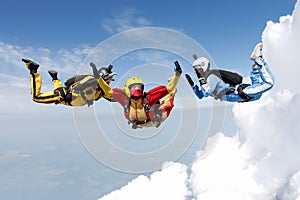 Skydiving. Two instructors are training a student to fly.