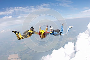 Skydiving. Two instructors are training a student to fly.