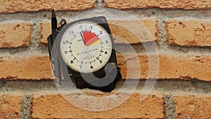 Skydiving altimeter, used by skydiver, with a pen for annotation, brick background, top view, zoom photo