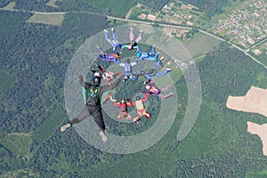 Skydiving. A cameraman makes photo and video about free falling skydivers.