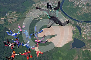 Skydiving. A cameraman makes photo and video about free falling skydivers.