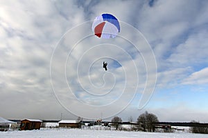 Skydiving. A circle color parachute is landing.