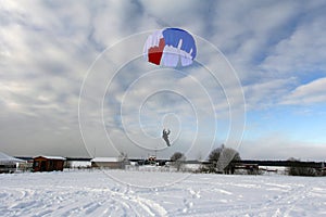 Skydiving. A circle color parachute is landing.