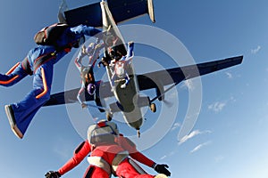 Skydiving. A few skydivers are jumping out of a big plane.