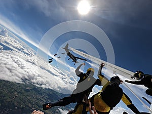 Skydiving formation above the clouds