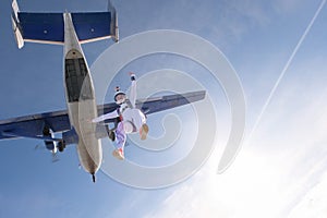 Skydiving. The free fall. Girl is in the sky.