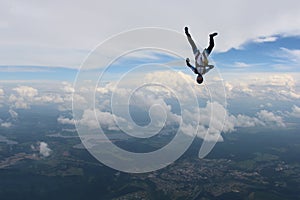 Skydiving. A girl is flying in the sky with a bouquet of flowers.