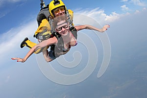 Skydiving. Girl and instructor are flying in the sky.