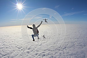 Skydiving. A group of skydivers are falling in the amazing sky.