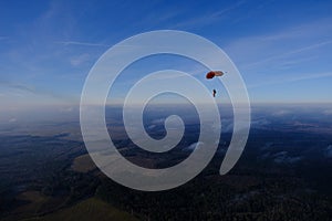 Skydiving. A parachute is flying in the sky.