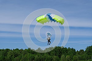 Skydiving. A parachute is in the sky.