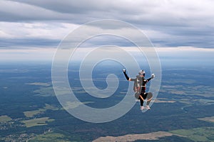 Skydiving. A pretty girl is sitiing in the sky.