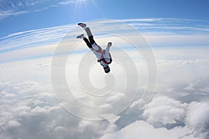 Skydiving. Skydiver is falling above clouds.