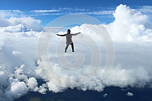 Skydiving. A skydiver is flying in the sky.