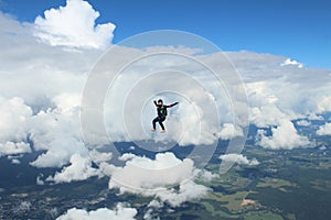 Skydiving. A skydiver is flying in the sky.