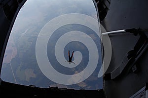 Skydiving. Skydiver is jumping out of a plane. The view from an airplane.