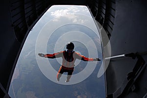 Skydiving. Skydiver is jumping out of a plane. The view from an airplane.