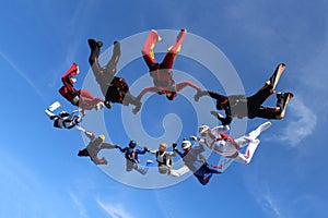 Skydiving. Skydivers are flying in the sky.