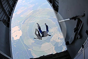 Skydiving. Skydivers are jumping out of a plane. The view from an airplane.