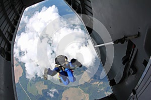 Skydiving. Skydivers are jumping out of a plane. The view from an airplane.