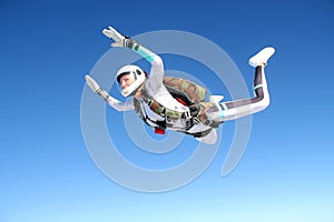 Skydiving. Solo jump. A girl is in the sky.