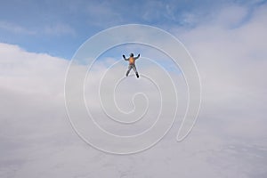 Skydiving. Solo jump. A pretty girl is in the sky.