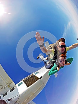 Skydiving tandem couple jump out the plane