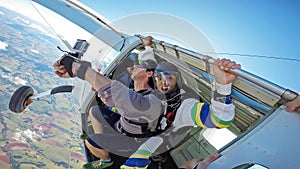 Skydiving tandem at the door of the plane