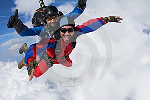 Skydiving. Tandem is flying in the clouds.