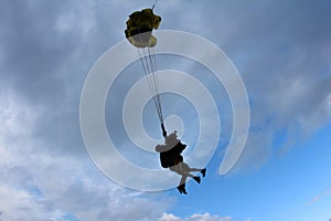 Skydiving. Tandem jump. Man and young woman are falling in the sky together.