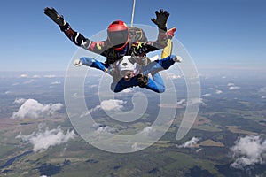 Skydiving. Tandem jump. Two people are in the sky.