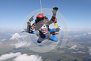 Skydiving. Tandem jump. Two people are in the sky.