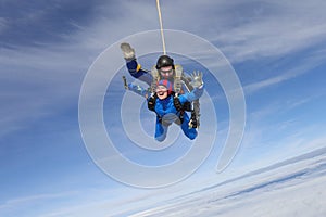 Skydiving. Tandem jump. Two people are in the sky.