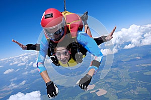 Skydiving. Tandem jump. Two skydivers are in the sky.