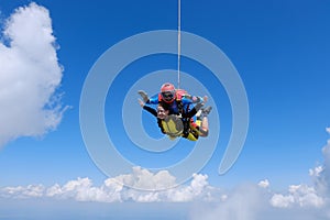 Skydiving. Tandem jump. Two skydivers are in the sky.