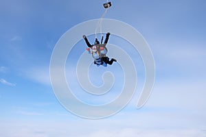 Skydiving. Tandem jump. Two skydivers are in the sky.